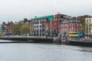 buildings, road, cars, and body of water