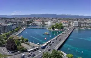 aerial view of city buildings near body of water during daytime